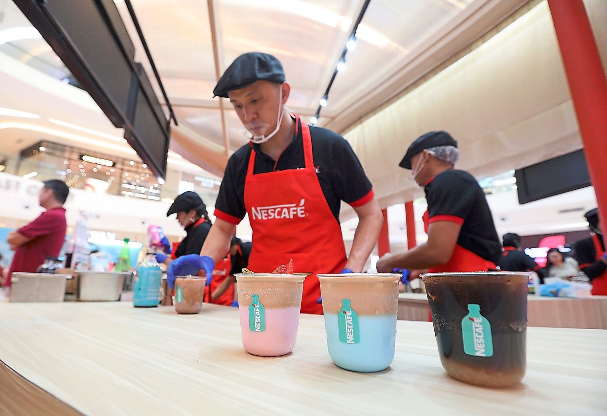 Baristas crafting cold coffee beverages at the ‘Hidupkan Duniamu Bersama Nescafe’ showcase.