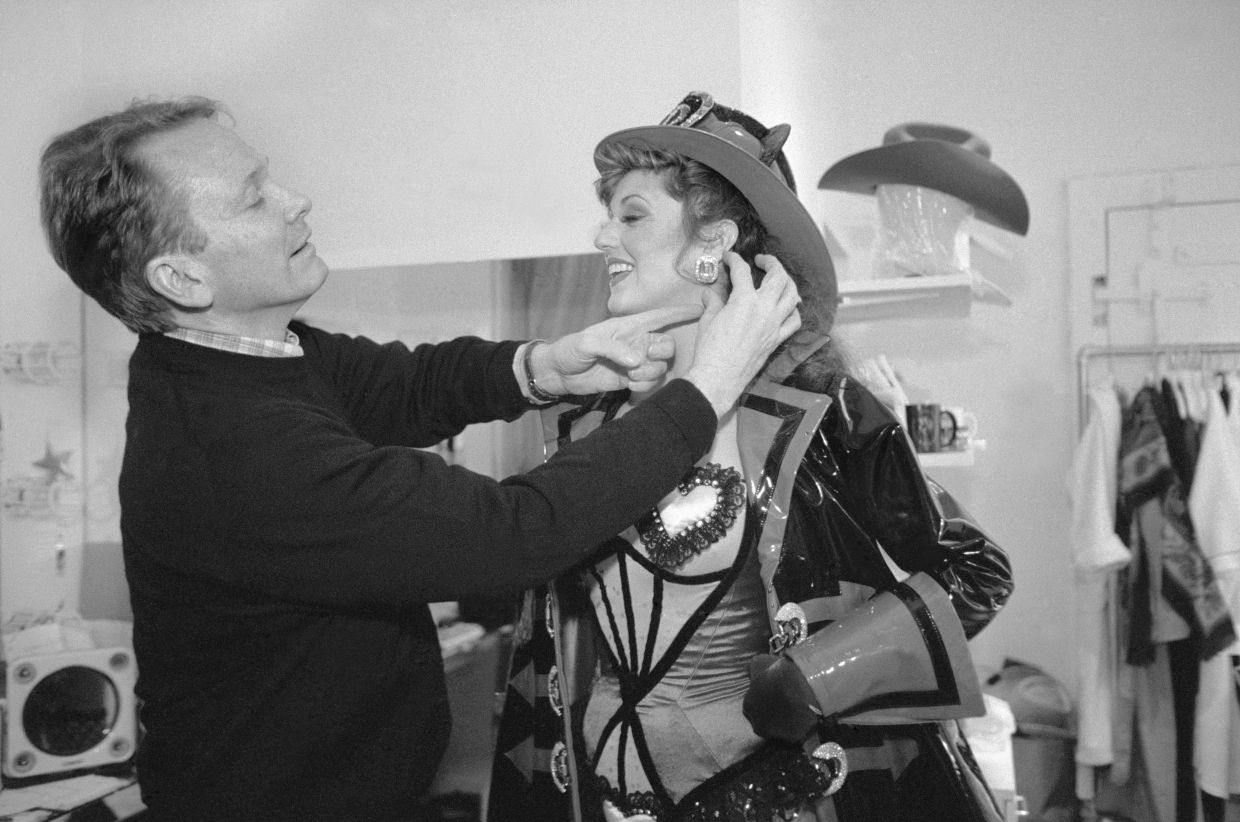 Bob Mackie with a performer in one of his costumes in 1994. Photo: The New York Times