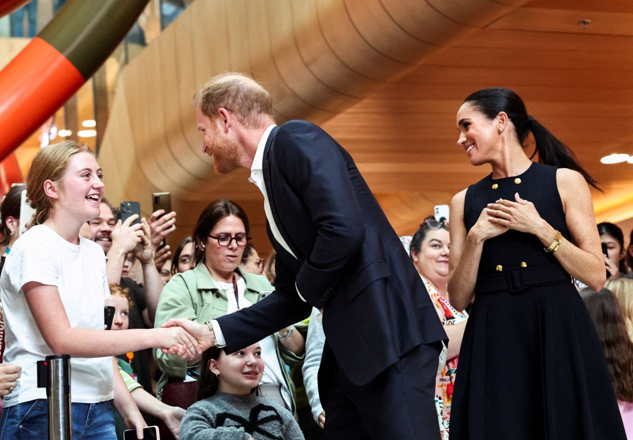 A file photo of Prince Harry, the Duke of Sussex, greeting a girl as he visits the Royal Children's Hospital along with Meghan, Duchess of Sussex, in Melbourne, Australia, April 14, 2026. Photo: Reuters