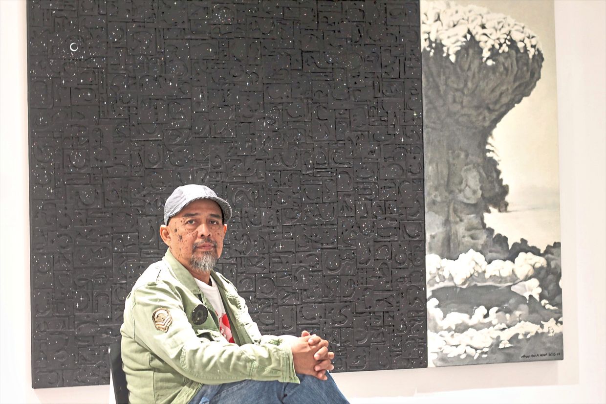 Shukri with his artwork 'Jangan Diusik Bintang Di Langit', which reflects on how the sky, a source of inspiration, can fade from view amid war and pollution. Photo: The Star/M. Irsyad