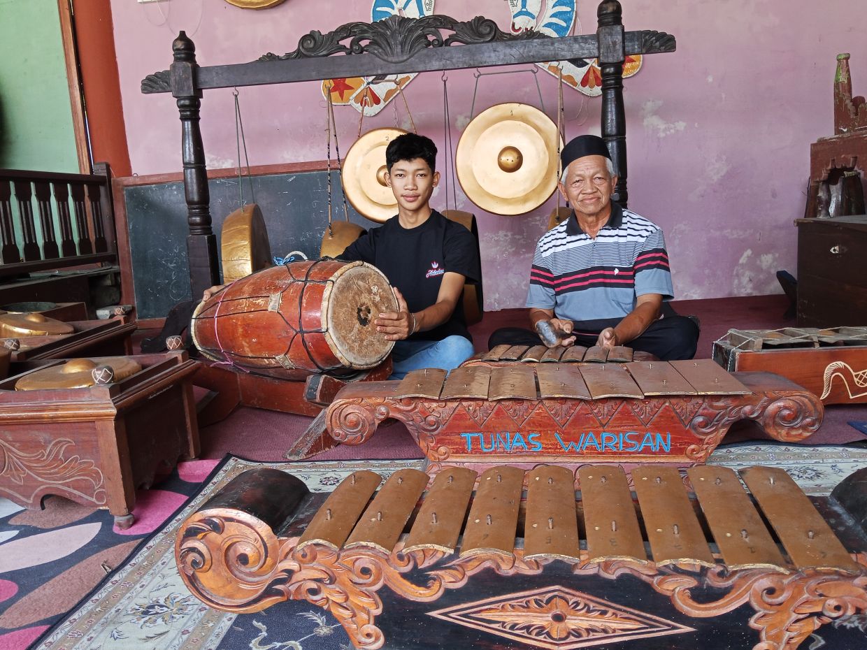 Amar Abu (right) with son Mohd Nizal Amar preserving the gamelan as a traditional art for the Johor Javanese community.