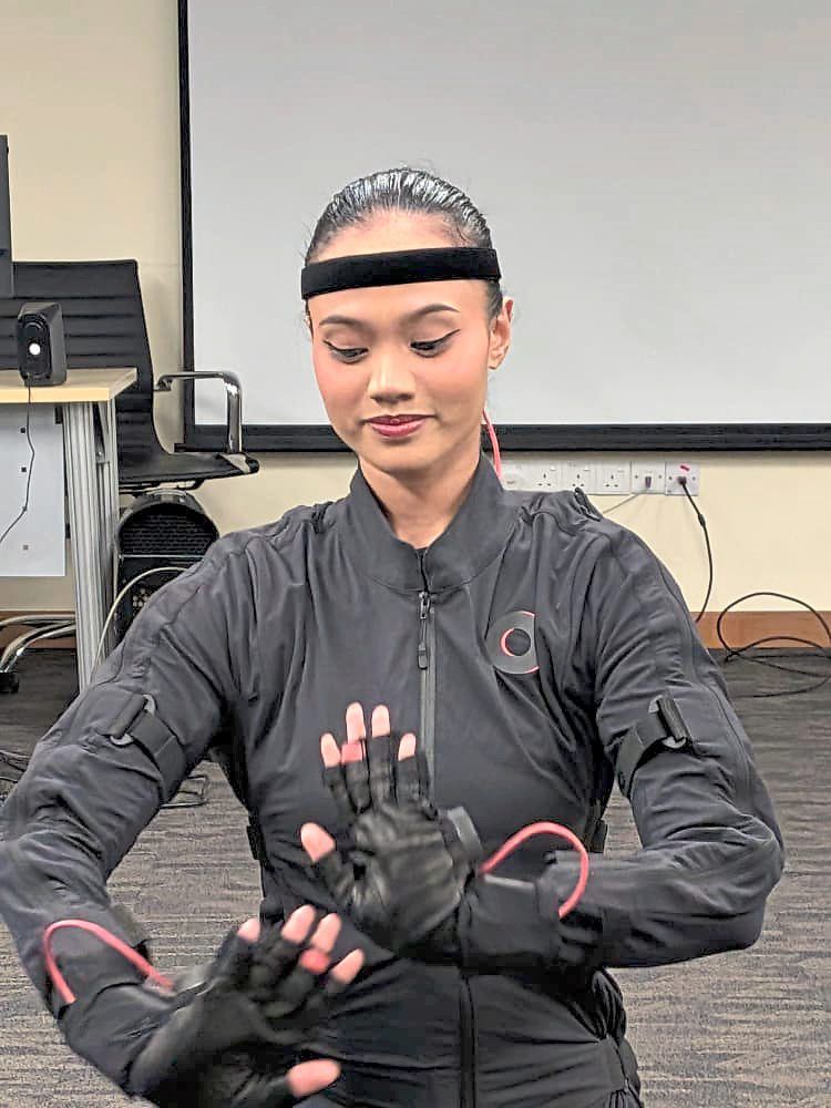 A dancer in a motion-capture suit prepares to record the movements of a traditional dance. — JAZMI JAMAL