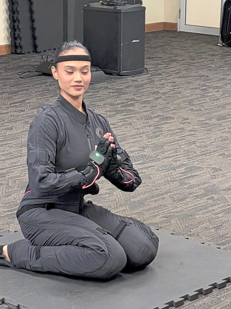 A dancer in a motion-capture suit prepares to record the movements of a traditional dance. — JAZMI JAMAL