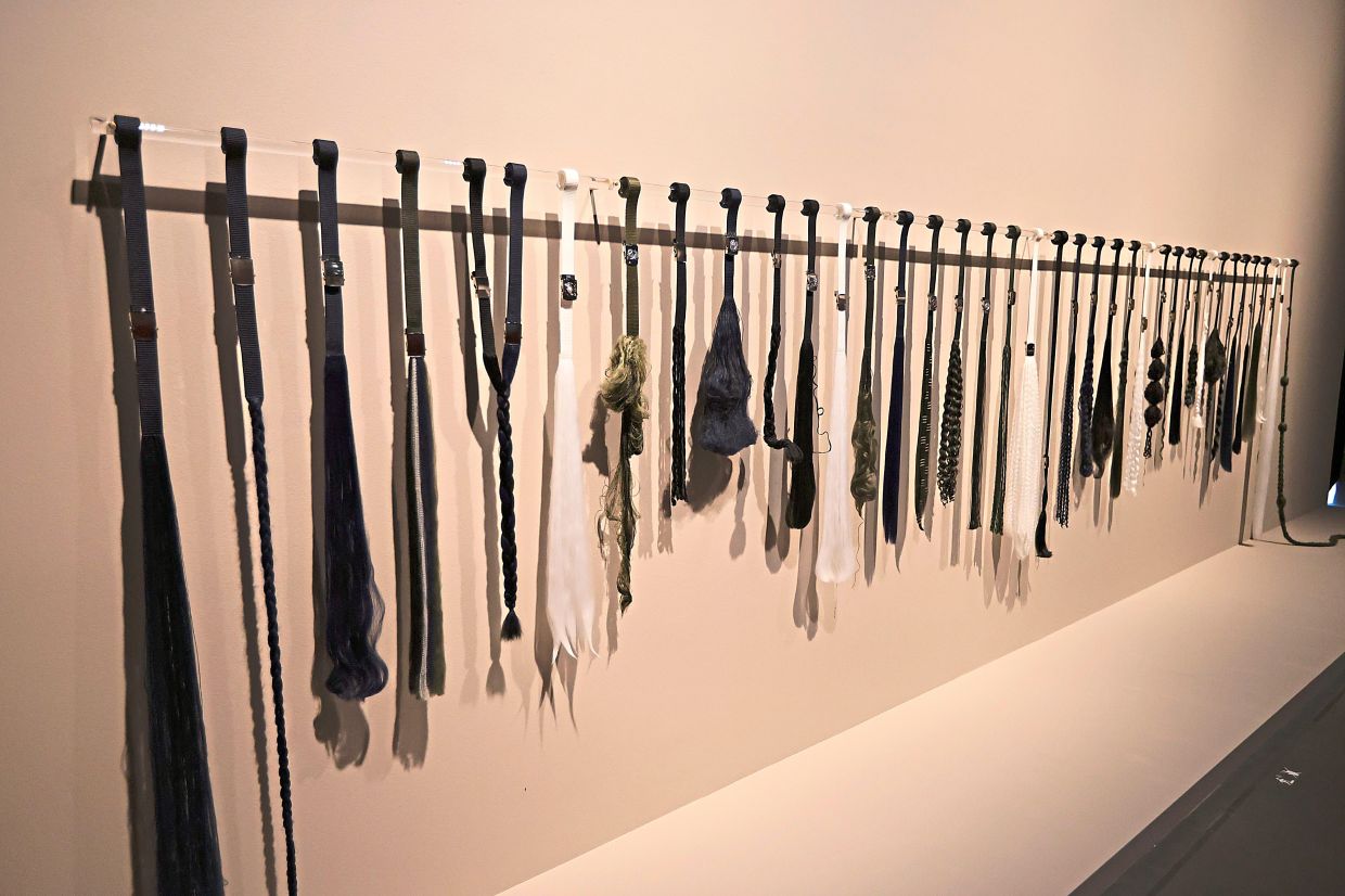 Umar's installation series 'Asuhan Dan Dandanan' (school belts, dimensions variable, 2025) seen at the Ilham Art Show 2025 at Ilham Gallery in KL last year. Photo: The Star/Low Boon Tat 