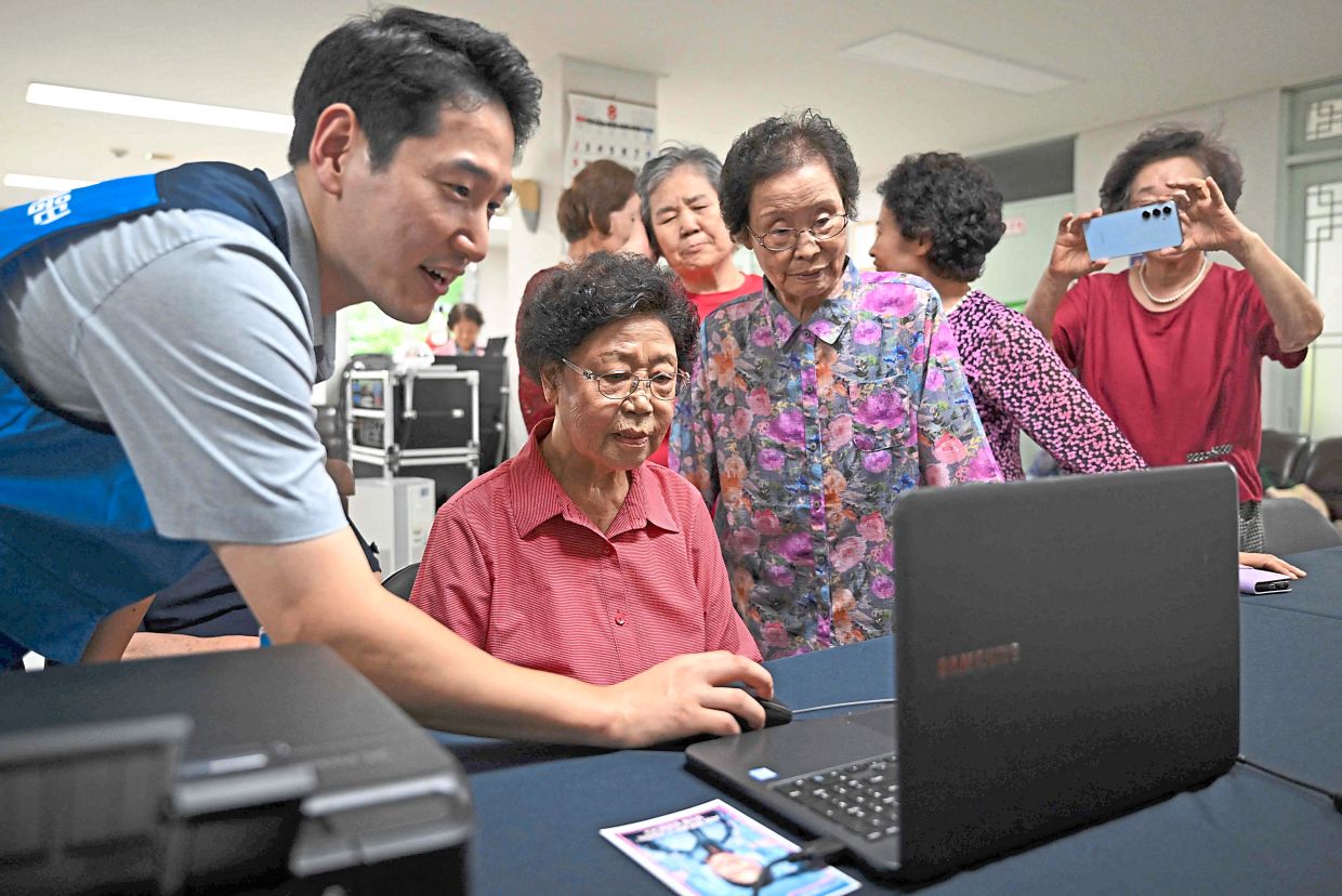 Keeping pace: Elderly people attending a government-organised digital survival training at a senior community centre in Suwon. — AFP