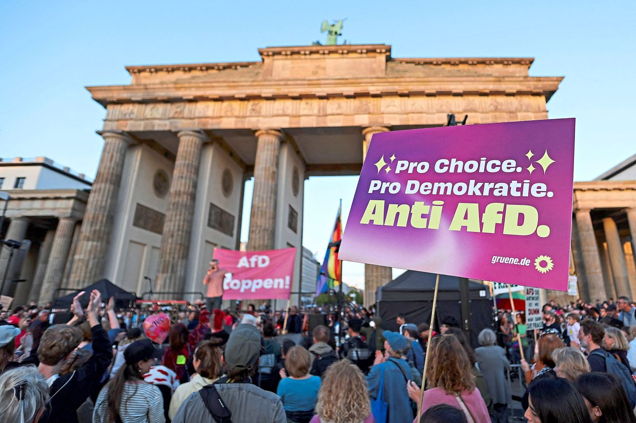 (Above and below) People protesting the day after AfD’s victory in the Saxony-Anhalt state elections at the Brandenburg Gate in Berlin. — Reuters