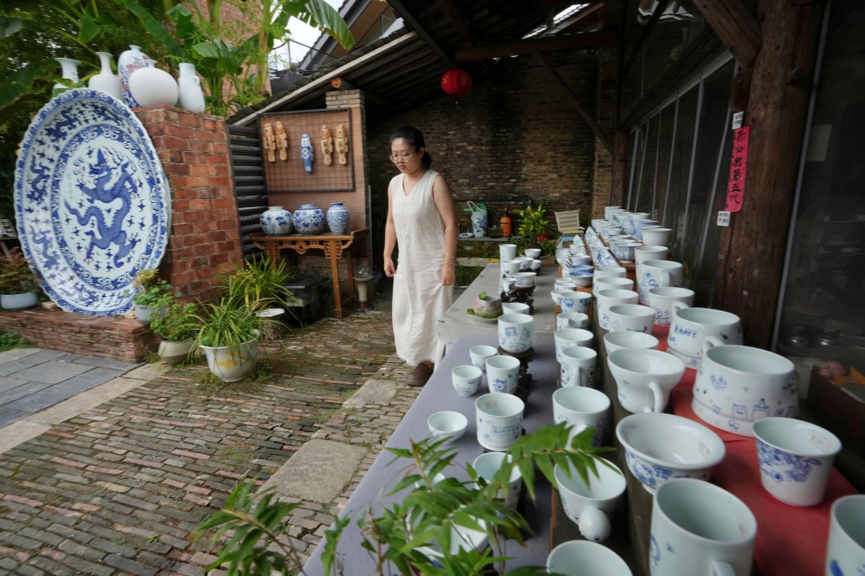 A woman walks at Taoyang alley historical and cultural tourist area in Jingdezhen.