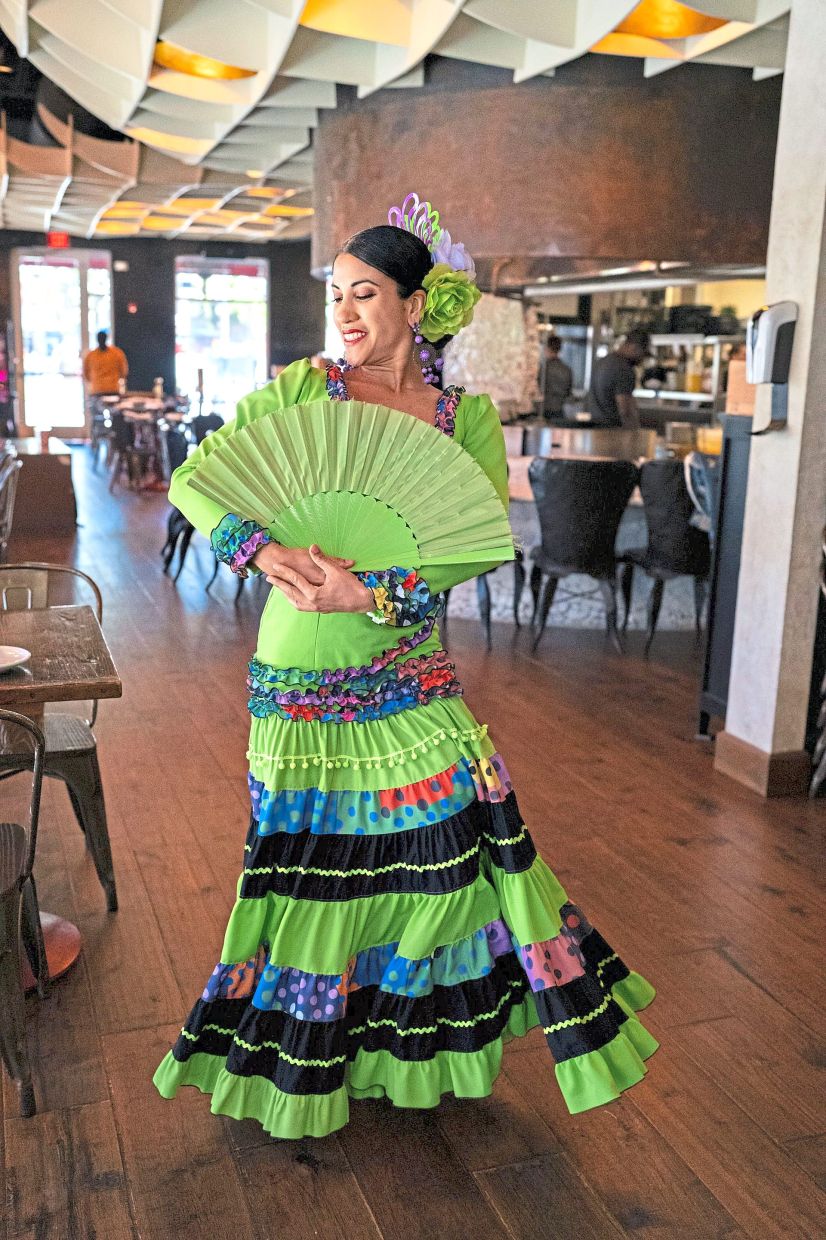 A flamenco dancer performing with an abanico.