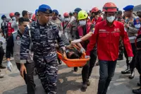 Indonesian rescuers plan to right capsized ship as weather hampers search for 129 missing people
