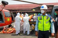 Indonesian rescuers plan to right capsized ship as weather hampers search for 129 missing people