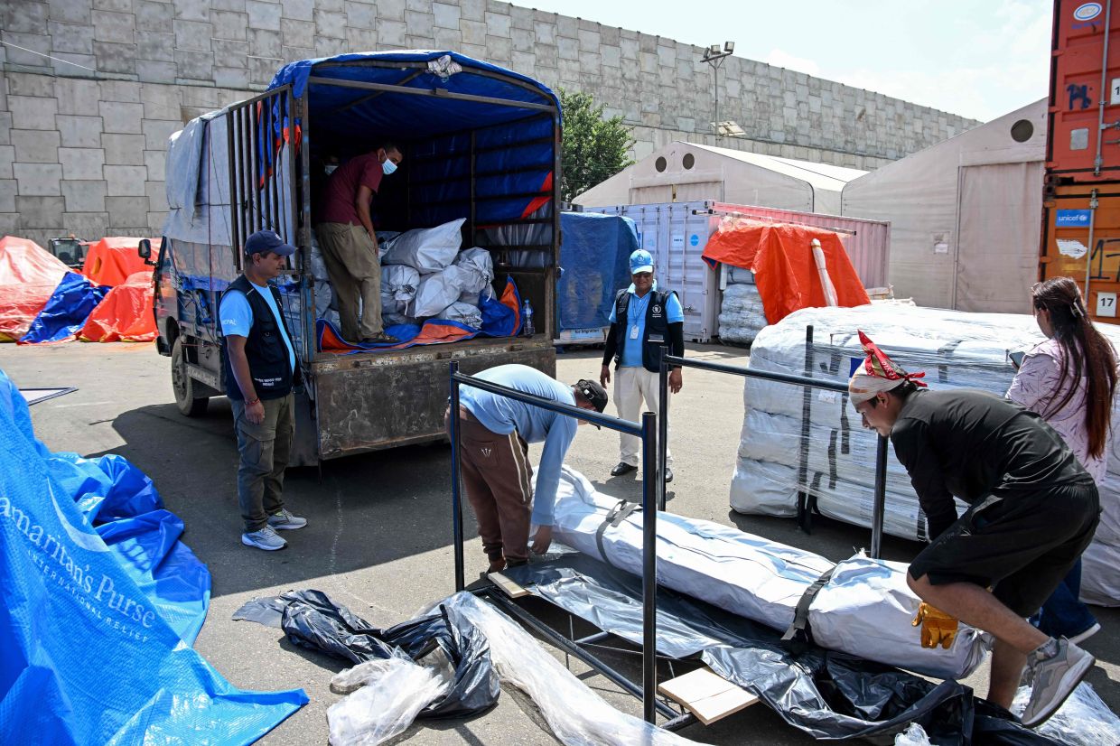 Workers unload emergency relief supplies from the United Nations World Food Programme (WFP) for flash flood victims at Tribhuvan International Airport's cargo area in Kathmandu on Sept 17, 2026. - Photo: AFP