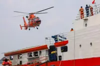 Indonesia begins operation to right capsized ship in Java Sea as 129 remain missing