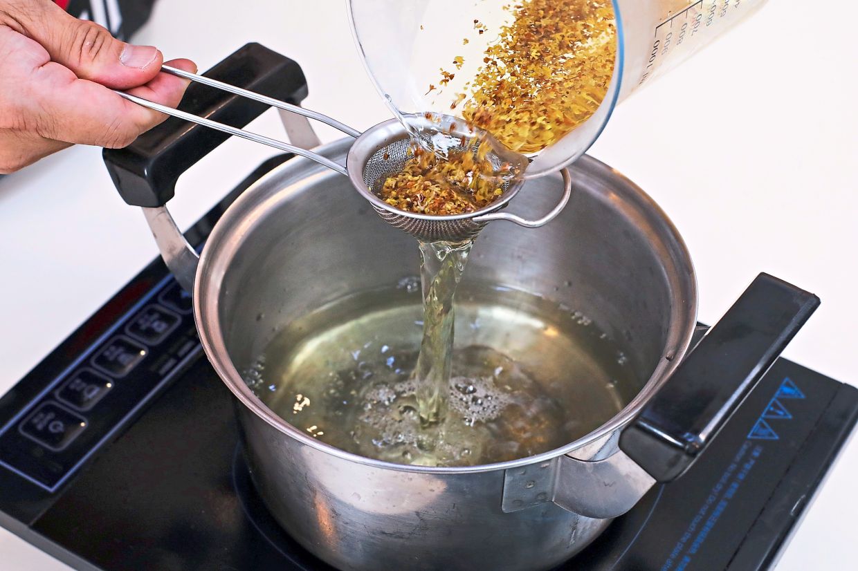 Strain the osmanthus tea into a saucepan, add sugar and boil until sugar is dissolved.