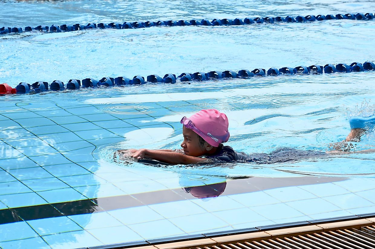 A young participant kicking her way forward during the event at the municipal pool in Kelana Jaya.