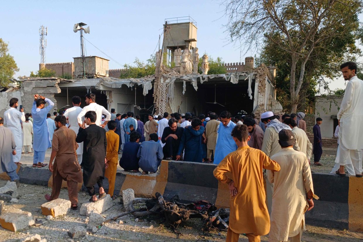 Onlookers gather at the site of an explosion inside the police headquarters at Kohat in Pakistan's Khyber Pakhtunkhwa province on Sept 18, 2026. An explosion at a historic police headquarters in northern Pakistan on Sept 18 killed at least eight people and wounded 35 more, officials said, with the country's president swiftly blaming a militant group. - Photo: AFP