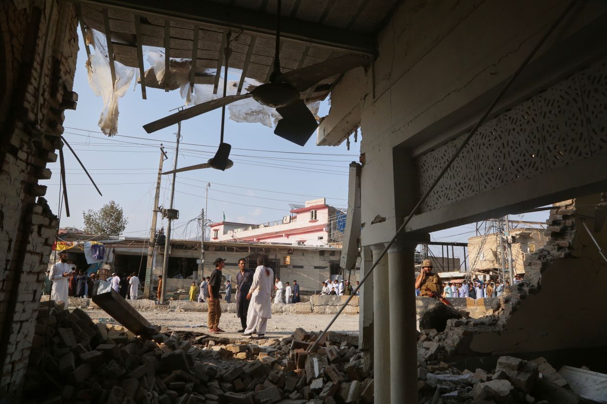 An Army soldier and local residents look at a damaged portion of a mosque after a bomb exploded in Kohat, in northwestern Pakistan, Friday, Sept 18, 2026. - Photo: AP