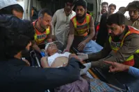 Six civilians, 15 police officers killed in twin bombings near police compound in northwestern Pakistan