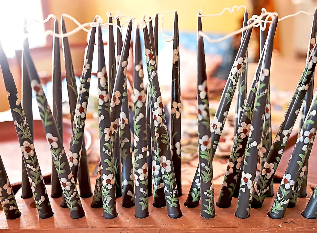 Saleh's hand-painted candles retail for approximately US$42 to US$50 a pair.