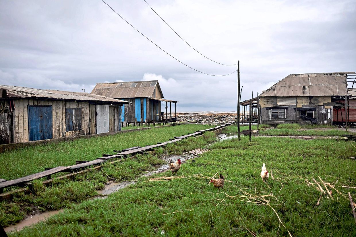 For many in Ayetoro, the question is no longer whether the sea will reach their home, but when.