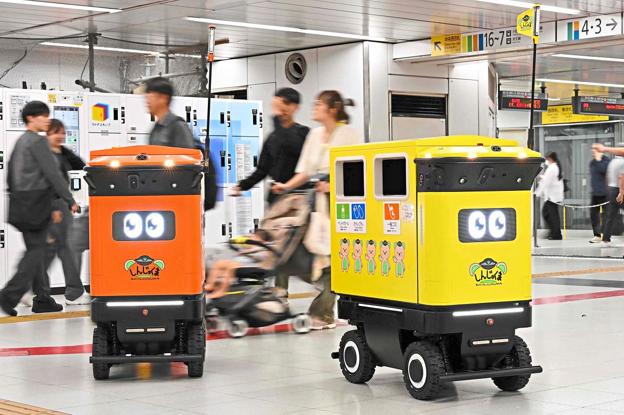 Mobile robotic trash bins are pictured during testing at the Shinjuku Station transport complex in Tokyo on September 18, 2026. The world's busiest railway station, located at the heart of Tokyo in Japan, is testing whether mobile robotic rubbish bins can ease the workload of sanitation workers, a rail operator representative said on September 18. (Photo by Toshifumi KITAMURA / AFP)