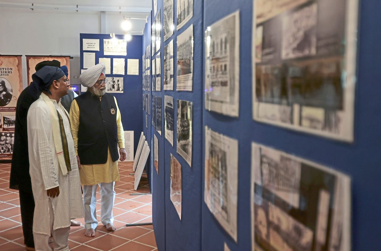 Visitors checking out an exhibition that traces the history of the building and Penang Sikh community.