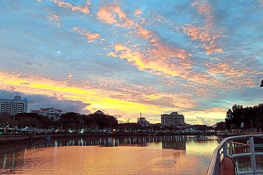 Cruise along Kuching’s Sarawak River as the sun sets over the city. — Sarawak River Cruise website