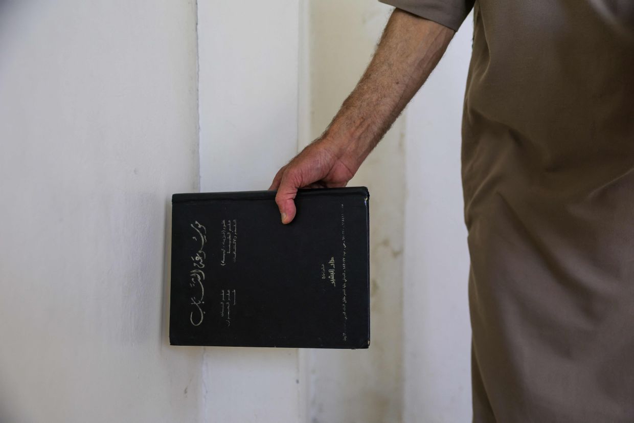 Mustafa Khaled Alwan hid his books for 15 years at the start of the uprising.