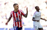 Soccer-Atletico ride derby storm to beat 10-man Real Madrid 2-1