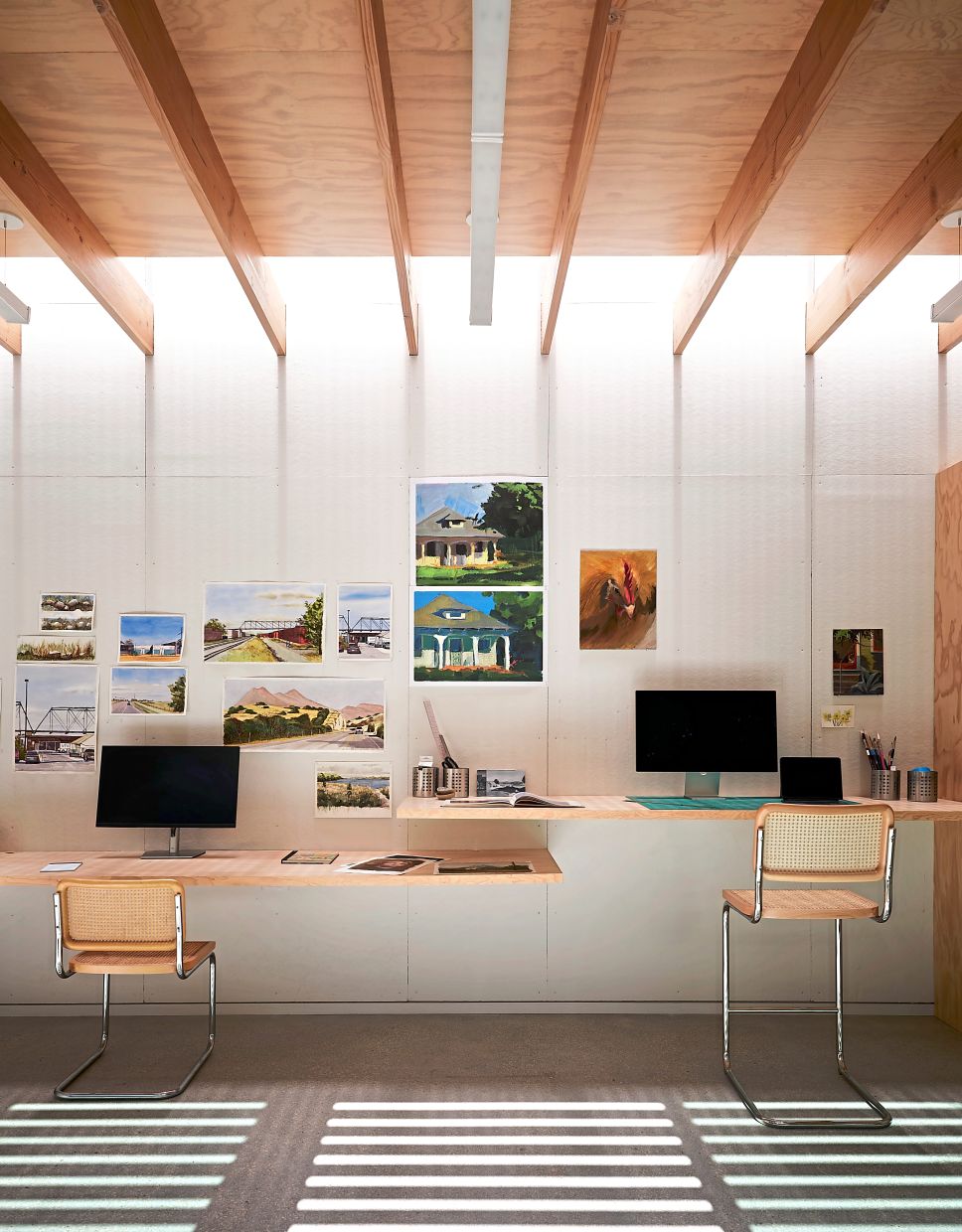 Instead of drywall, the walls of the art studio are finished in sound board, which readily accepts thumb tacks.