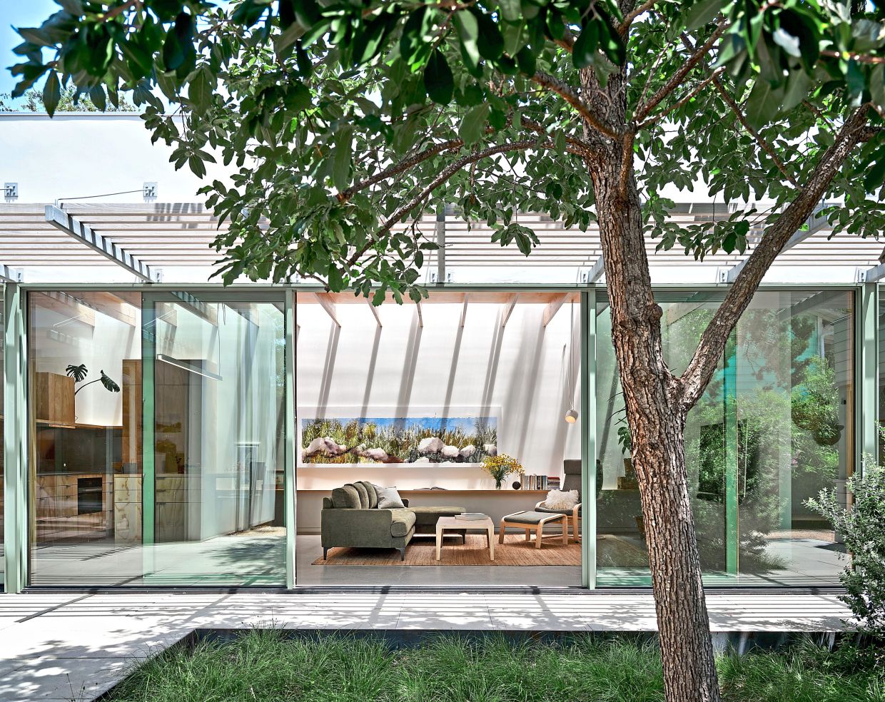 The design includes full-height, full-width glazing facing the inside courtyard.