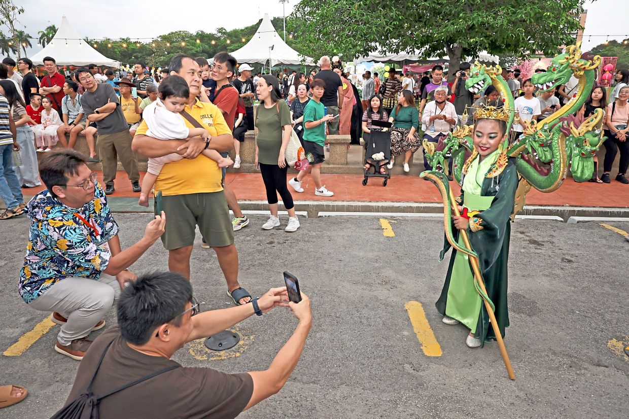 Wan Intan Mahiya’s outfit with multiple green dragon heads drawing onlookers at the Chinese Traditional Character Cosplay and Costume Competition for the Penang Mid-Autumn Festival 2026 in George Town.