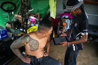 In Cambodia's 'Waiting Village', tattooist mourns trade lost to war