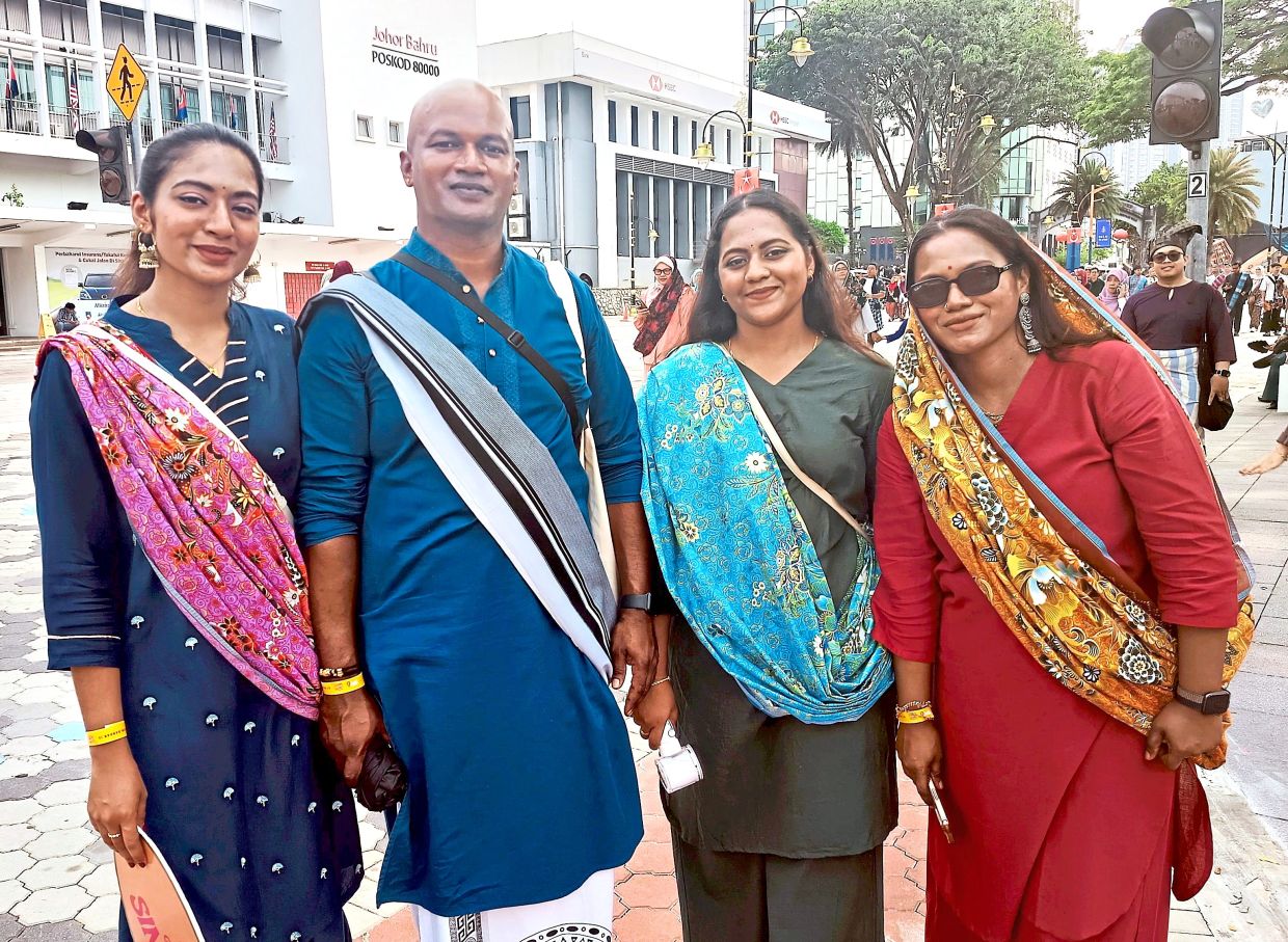 Priya (second from right) with her family members wearing traditional attire for the Keretapi Sarong event.