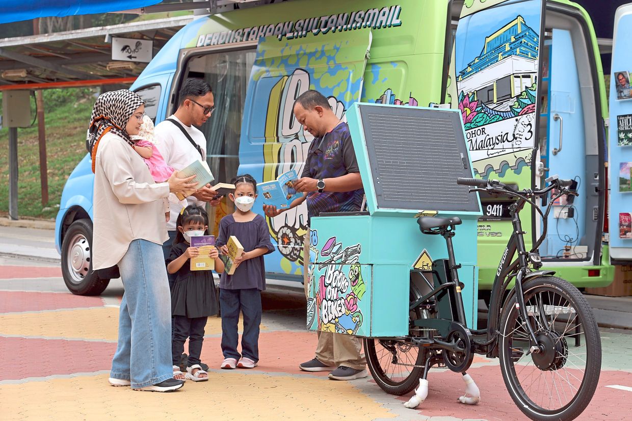 Visitors checking out books from a mobile library during the event.