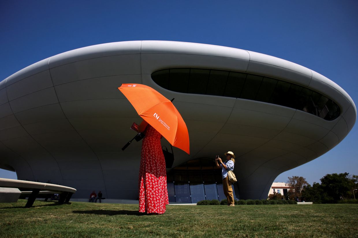 Visitors take pictures in the gardens at the Lucas Museum of Narrative Art during its opening on Sept 22. Photo: Reuters