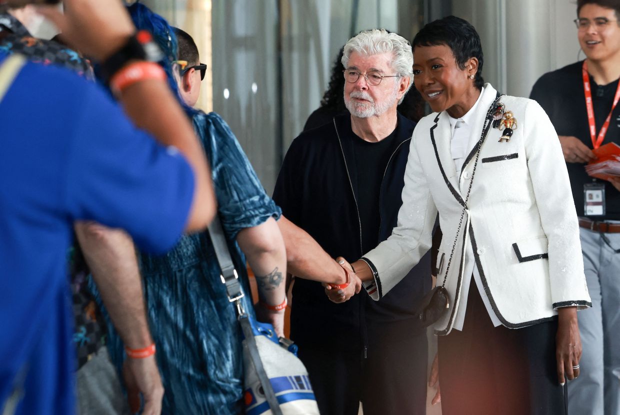 Lucas (left) and his wife businesswoman Mellody Hobson greet visitors as they enter the lobby of the Lucas Museum of Narrative Art on Sept 22. Photo: AFP