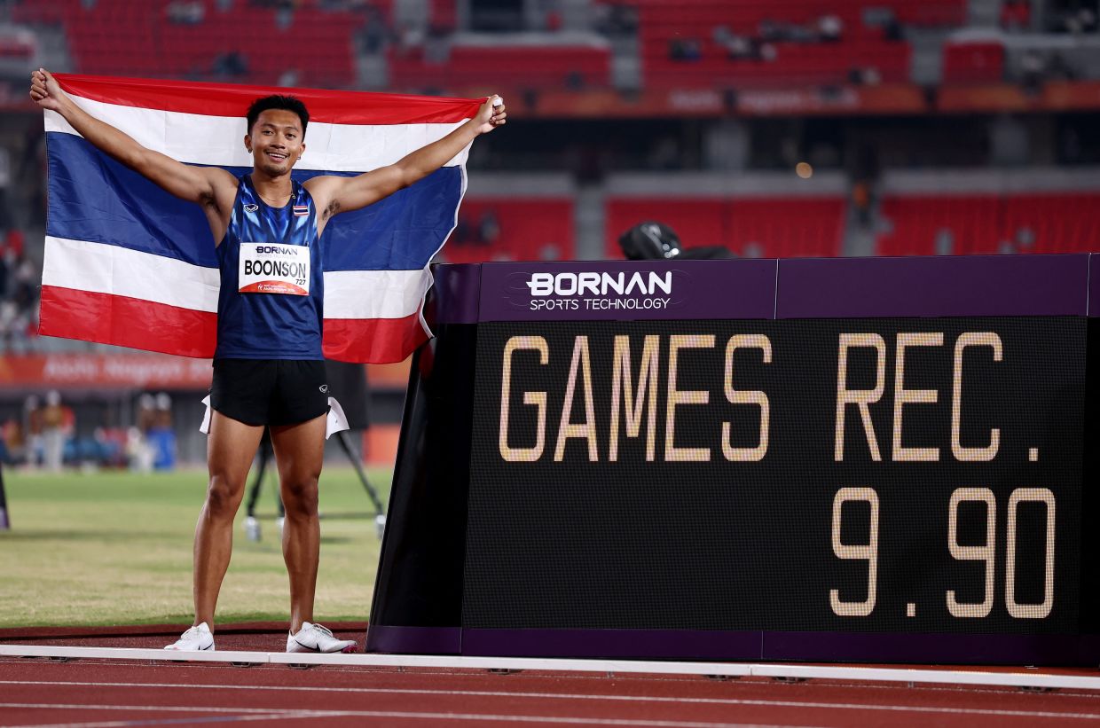 Thailand's Puripol Boonson celebrates after winning the men's 100m gold with a Games record. -REUTERS