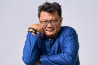 Local singer Hasnol, 56, living at workers' quarters, turns to e-hailing & busking to stay afloat