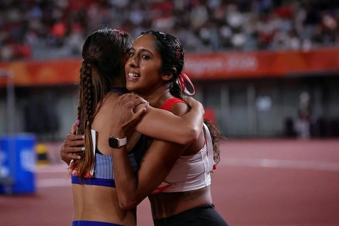 Shanti Pereira of Singapore hugging Liao Yan-jun of Taiwan after the Asian Games women’s 100m athletics semi-final at the Paloma Mizuho Stadium in Nagoya, Japan, on Sept 25. -- ST PHOTO: KEVIN LIM