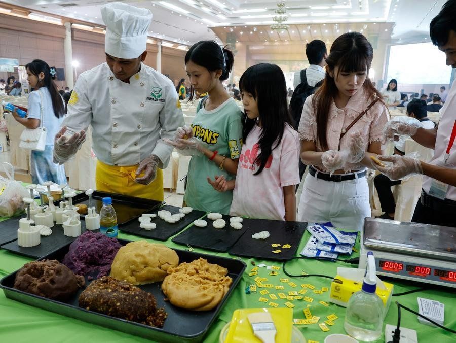 People make mooncakes during an event to celebrate the upcoming Mid-Autumn Festival in Yangon, Myanmar, Sept. 23, 2026. - Photo: Xinhua
