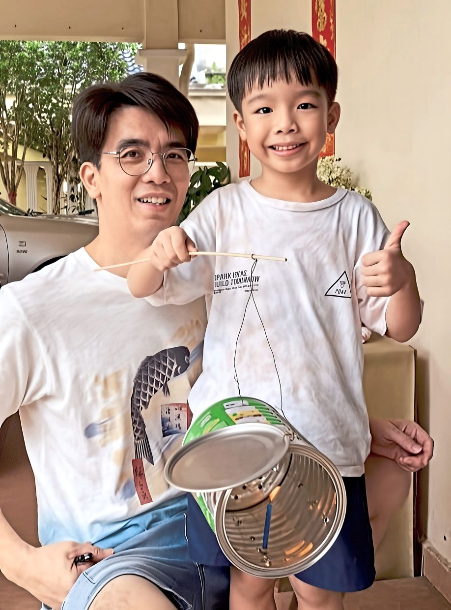 Like father, like son: Er and Yi Nuo showing off their handiwork at their home in Johor Baru.