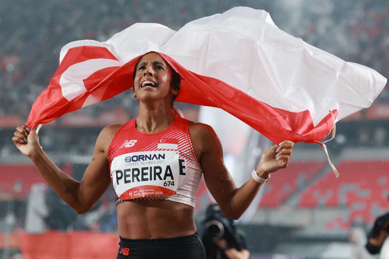 Singapore's Veronica Shanti Pereira celebrates after winning the women's 200m final. - AFP