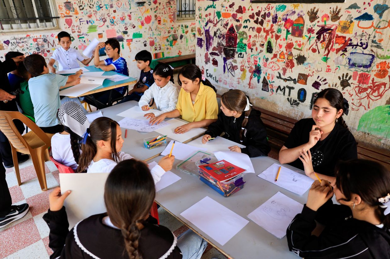 A group of Palestinian children attend a drawing workshop at Rommana studio in Hebron, in the Israeli-occupied West Bank. Photo: Reuters