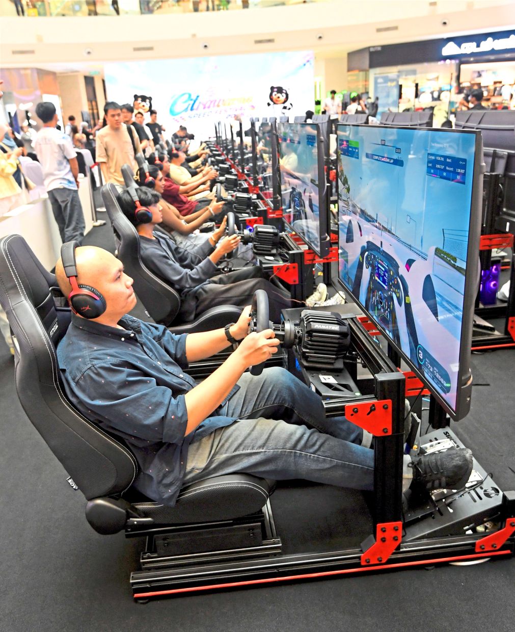 Visitors can take part in a driving simulator competition at Citrawarna Speed Festival at IOI City Mall Putrajaya. — AZHAR MAHFOF/The Star