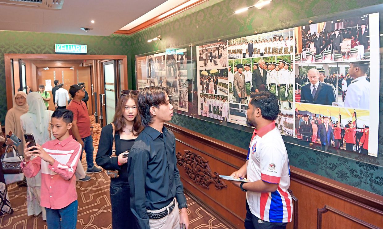 Visitors view a photographic display documenting official events and visits that have taken place at the complex.