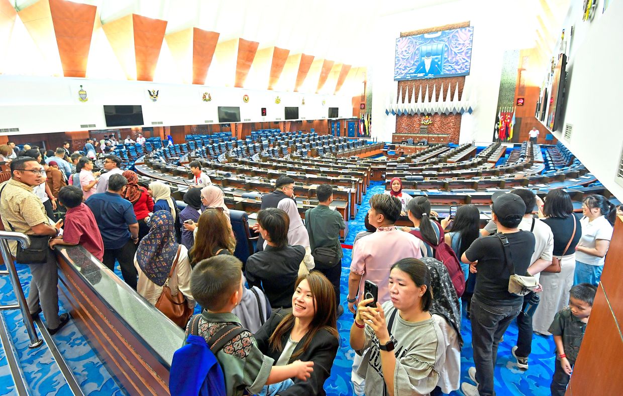 Members of the public exploring Dewan Rakyat, where MPs meet for parliamentary sittings.