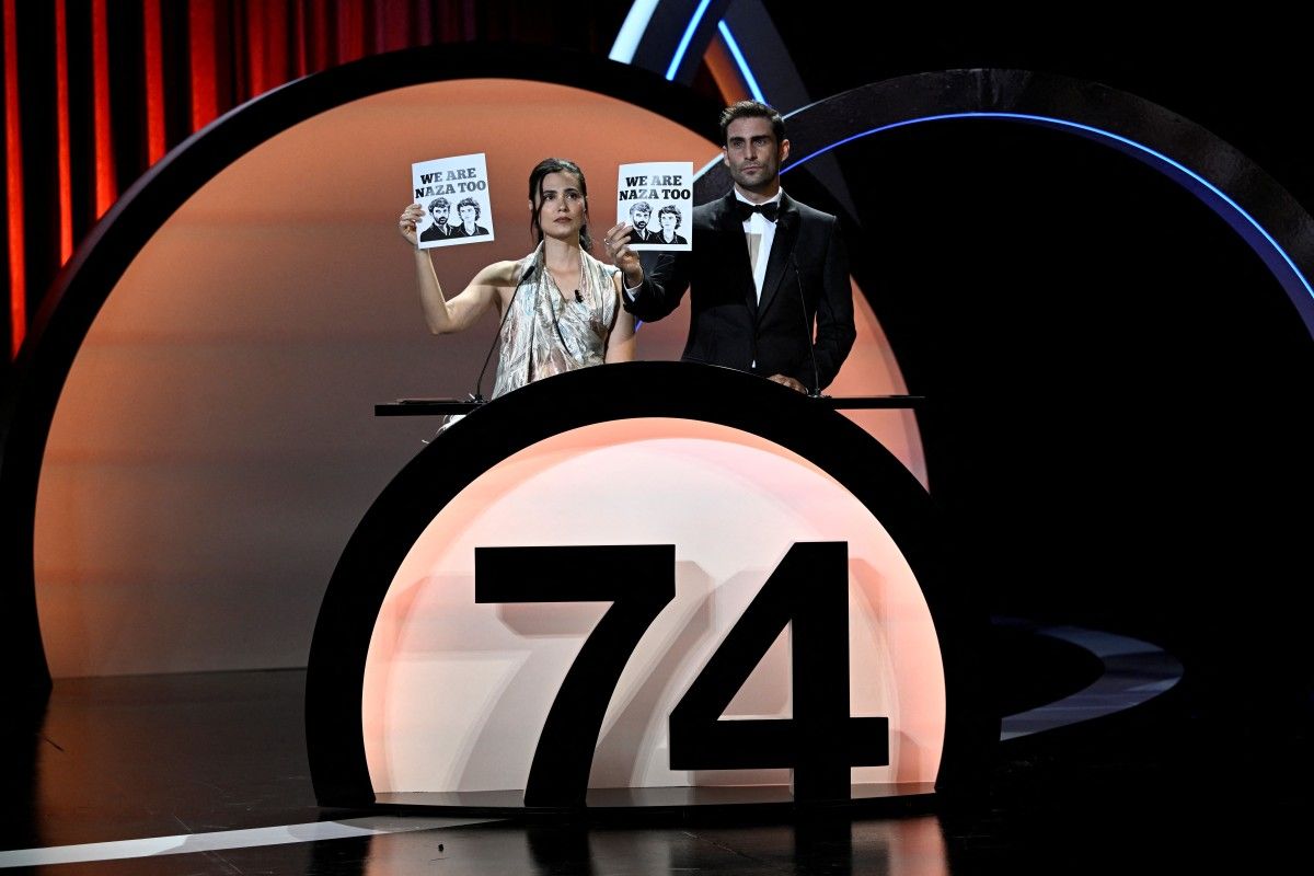 Global support: Actors Loreto Mauleon (left) and Fernando Guallar hold signs in support of NAZA at the 74th San Sebastian International Film Festival closing ceremony. — AFP