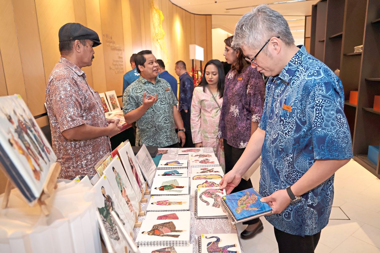 Visitors browsing at a booth featuring Malaysian craft during the event at Amari Kuala Lumpur.