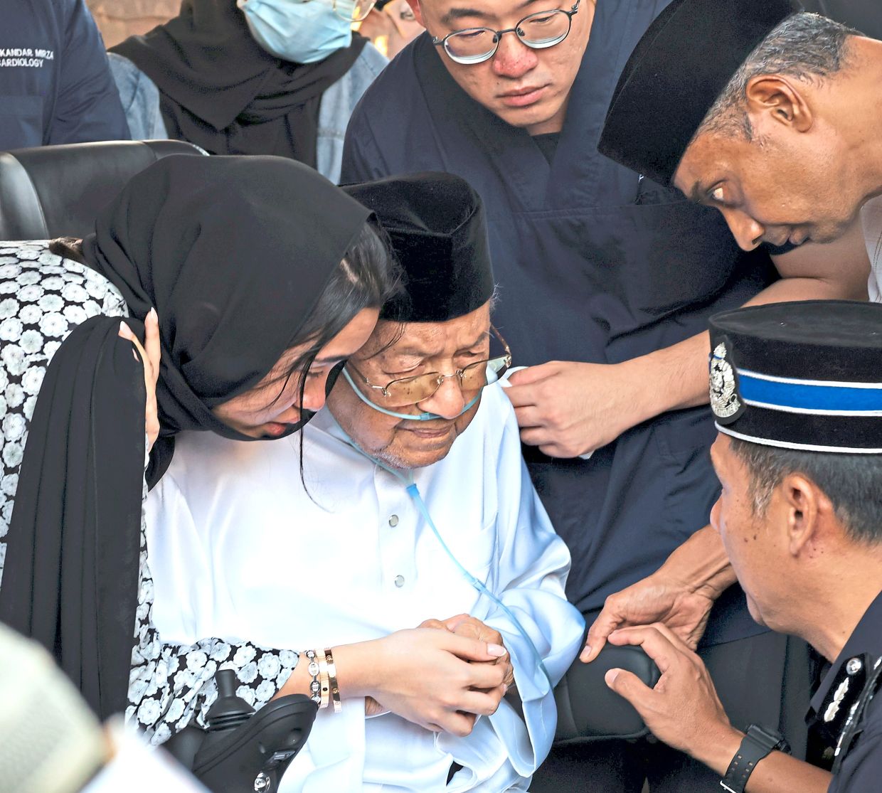 Comfort in grief: Dr Mahathir being consoled at his wife’s funeral. — CHAN TAK KONG/The Star 