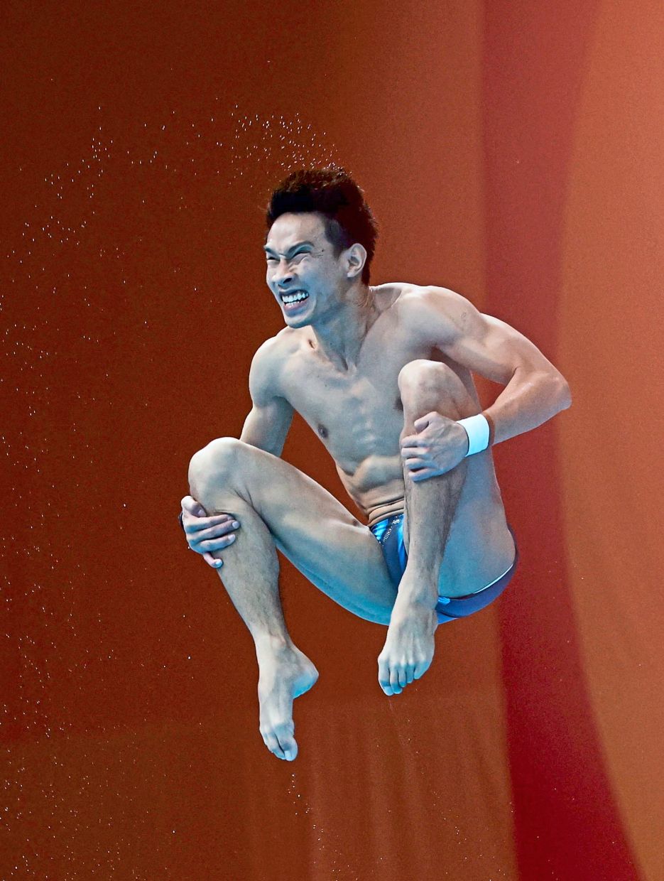 Total focus: Mohd Syafiq Puteh in action during the 1m springboard event. — Reuters